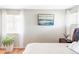 Bright main bedroom with large windows, neutral wall paint, and hardwood floors at 11647 E Wesley Ave, Aurora, CO 80014
