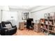 Well-lit office featuring wooden desk, book shelves, and a comfortable chair at 11647 E Wesley Ave, Aurora, CO 80014
