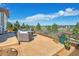 Spacious backyard patio with seating area and mountain views at 3338 Youngheart Way, Castle Rock, CO 80109