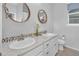 Bathroom with double vanity and round mirrors at 3338 Youngheart Way, Castle Rock, CO 80109