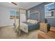 Spacious bedroom with a gold canopy bed and sitting area at 3338 Youngheart Way, Castle Rock, CO 80109
