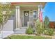 Front porch with stone accents, wreath, and American flag at 3338 Youngheart Way, Castle Rock, CO 80109
