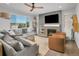 Spacious living room with a fireplace, large windows, and comfortable seating at 3338 Youngheart Way, Castle Rock, CO 80109