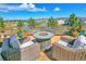 Patio with fire pit and wicker chairs, offering scenic views at 3338 Youngheart Way, Castle Rock, CO 80109