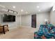 Basement space with TV, eclectic furniture, and a blue-paneled door at 3559 Hudson St, Denver, CO 80207