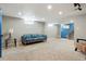 Spacious basement with neutral carpet and bright, colorful furniture at 3559 Hudson St, Denver, CO 80207