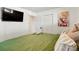 Bright bedroom with an accent painting, television and a closet with double doors at 3559 Hudson St, Denver, CO 80207