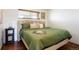 Comfortable bedroom featuring a soft headboard and a window with natural light at 3559 Hudson St, Denver, CO 80207