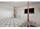Bedroom features a four-poster bed, television, and closet at 3559 Hudson St, Denver, CO 80207
