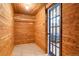 Wood-paneled walk-in closet with blue paneled door at 3559 Hudson St, Denver, CO 80207