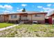 Charming single-story home with brick accents, covered porch and walkway with beautiful landscaping at 3559 Hudson St, Denver, CO 80207