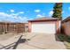 Exterior view of a white garage door, concrete driveway, and backyard fence at 3559 Hudson St, Denver, CO 80207