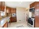 Modern kitchen with stainless steel appliances, wood cabinets, tile flooring and granite countertops at 3559 Hudson St, Denver, CO 80207