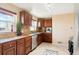 Well-lit kitchen featuring wood cabinets, granite countertops, stainless steel appliances, and tile flooring at 3559 Hudson St, Denver, CO 80207