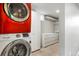 Laundry area with modern washer/dryer, cabinet and closet at 3559 Hudson St, Denver, CO 80207