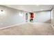 Spacious living room featuring neutral paint, carpet flooring, and unique wall sconces at 3559 Hudson St, Denver, CO 80207