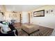 Bright living room features hardwood floors, stylish furniture and large accent mirror at 3559 Hudson St, Denver, CO 80207