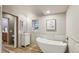 Stylish bathroom with soaking tub, modern vanity, and walk-in shower at 20033 Silver Ranch Rd, Conifer, CO 80433