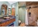 Rustic bathroom with tiled shower and unique stone sink at 20033 Silver Ranch Rd, Conifer, CO 80433