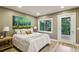 Bright bedroom features wood floors, a large window, and a scenic outdoor view at 20033 Silver Ranch Rd, Conifer, CO 80433