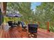 Spacious wood deck features an outdoor dining set with seating and beautiful views of the surrounding trees at 20033 Silver Ranch Rd, Conifer, CO 80433