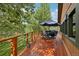 Outdoor deck furnished with a dining set, offering a relaxing space with scenic views of the surrounding landscape at 20033 Silver Ranch Rd, Conifer, CO 80433