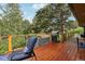 Relaxing wood deck area showcases a grill, lounge chair and beautiful views of the mature trees at 20033 Silver Ranch Rd, Conifer, CO 80433