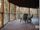 Enjoy outdoor living on this deck with glass railings and space for seating among the trees at 20033 Silver Ranch Rd, Conifer, CO 80433