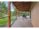 Relax outdoors on this wooden deck overlooking lush greenery, complete with glass railings and comfortable seating at 20033 Silver Ranch Rd, Conifer, CO 80433