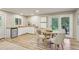 Open dining area features a table with chairs and a view of the lush backyard at 20033 Silver Ranch Rd, Conifer, CO 80433