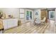 Bright dining area with wood floors, a barn door, and white cabinets at 20033 Silver Ranch Rd, Conifer, CO 80433