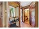 Hallway has custom wood trim and built-in storage with access to the uniquely designed powder room at 20033 Silver Ranch Rd, Conifer, CO 80433