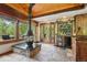 Cozy kitchen space with a modern fireplace, a breakfast bar, and an adjacent dining area overlooking a lush outdoor landscape at 20033 Silver Ranch Rd, Conifer, CO 80433