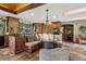 Large kitchen with wood cabinets, granite counters, banquette seating and stone floors at 20033 Silver Ranch Rd, Conifer, CO 80433