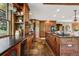 Spacious kitchen featuring beautiful wood cabinets, stone tile floors, and modern appliances at 20033 Silver Ranch Rd, Conifer, CO 80433