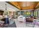 Comfortable living area with wood-trimmed windows offering views, complemented by stylish furniture and ample natural light at 20033 Silver Ranch Rd, Conifer, CO 80433