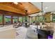 Open-concept living space with a distinctive fireplace, wood ceilings, and large windows providing picturesque views at 20033 Silver Ranch Rd, Conifer, CO 80433