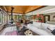 Inviting living room featuring wood beam ceilings, a cozy fireplace, and an open floor plan with view to the backyard at 20033 Silver Ranch Rd, Conifer, CO 80433