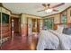 Spacious main bedroom features wood accents, hardwood floors, ceiling fan, and ensuite bathroom at 20033 Silver Ranch Rd, Conifer, CO 80433