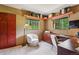 Bright office space features custom desk, carpeted floors, and plenty of natural light from the windows at 20033 Silver Ranch Rd, Conifer, CO 80433