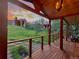 Charming wood porch with cable railings, hanging baskets, and sunset views at 20033 Silver Ranch Rd, Conifer, CO 80433