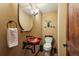Powder room features dark wood accents and a unique sink and mirror at 20033 Silver Ranch Rd, Conifer, CO 80433