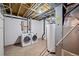 Unfinished basement area with laundry area featuring a newer washer and dryer at 2748 S Kenton Ct, Aurora, CO 80014
