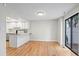 Bright dining area featuring hardwood floors, a bar counter, and a sliding glass door at 2748 S Kenton Ct, Aurora, CO 80014