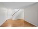 Bright entryway featuring hardwood floors, a white door, and a staircase with white railing at 2748 S Kenton Ct, Aurora, CO 80014