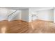 Open-concept living area with hardwood floors, a staircase, and a kitchen pass-through at 2748 S Kenton Ct, Aurora, CO 80014