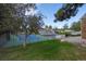 Well-maintained tennis court surrounded by lush greenery, mature trees and fencing at 2748 S Kenton Ct, Aurora, CO 80014
