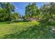 A small house on an overgrown lot at 1930 Hoyt St, Lakewood, CO 80215