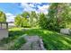Large backyard with fire pit surrounded by lush greenery at 1930 Hoyt St, Lakewood, CO 80215