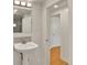 Bright bathroom featuring a pedestal sink and access to an adjacent space, blending function and style seamlessly at 1930 Hoyt St, Lakewood, CO 80215
